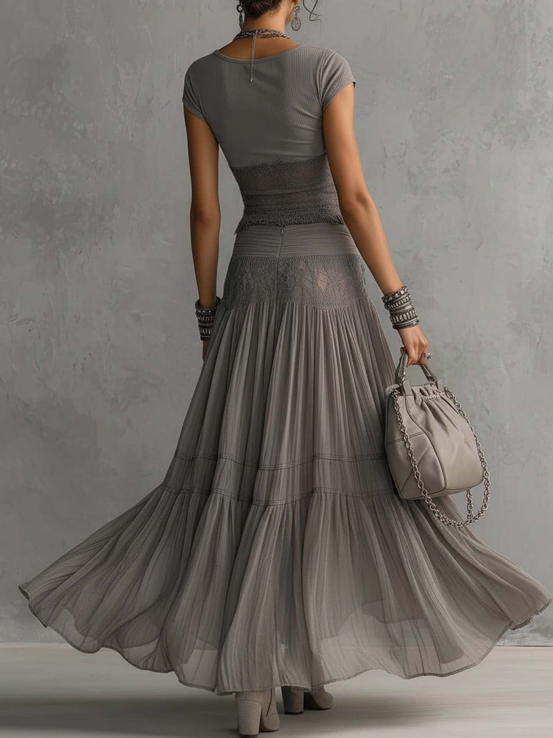 Gray tiered maxi skirt with short sleeve top, back view with a bag