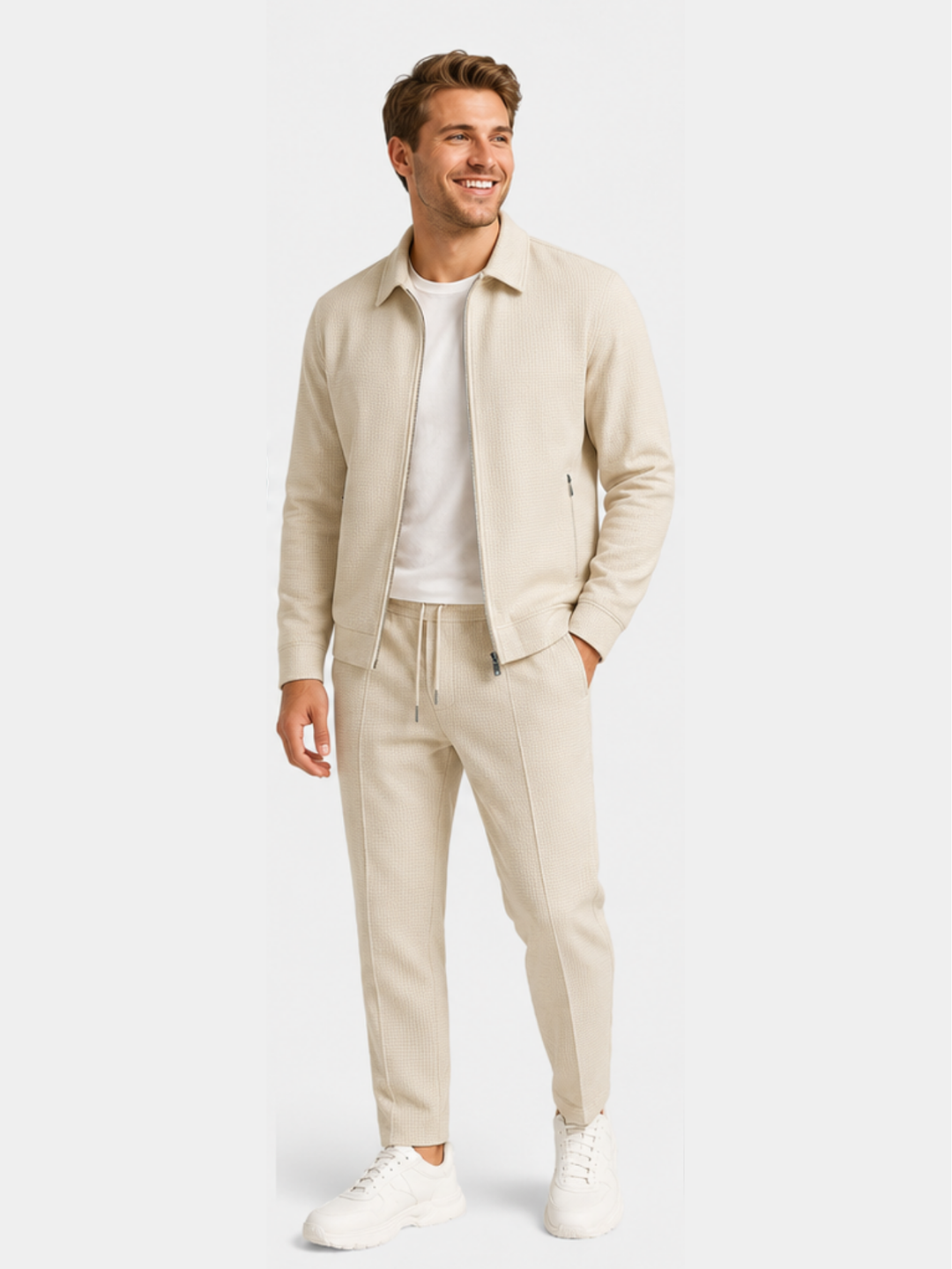 Khaki jacket and jogger pants set worn with a white tee and sneakers