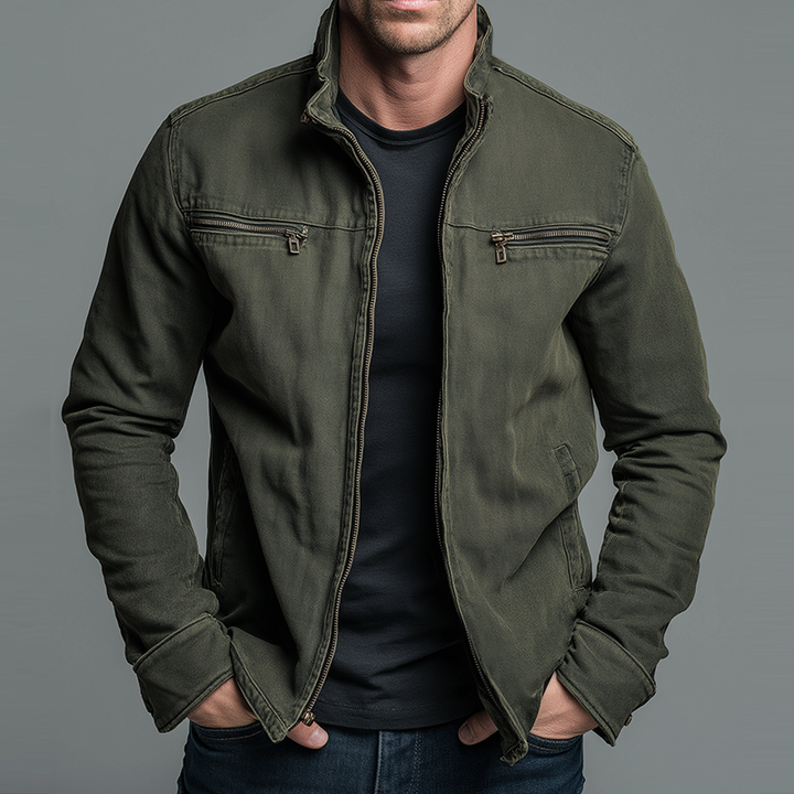 Olive zip front utility jacket with zippered chest pockets, hands in pockets