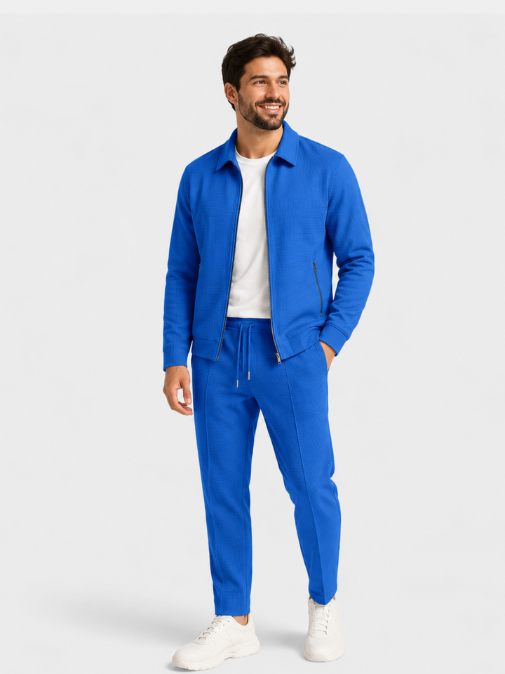 Bright royal blue zip up jacket and jogger pants set, hands in pockets