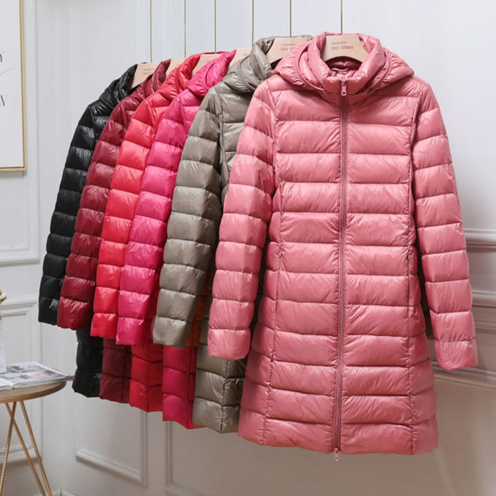 Row of lightweight quilted puffer coats in several colors on a rail