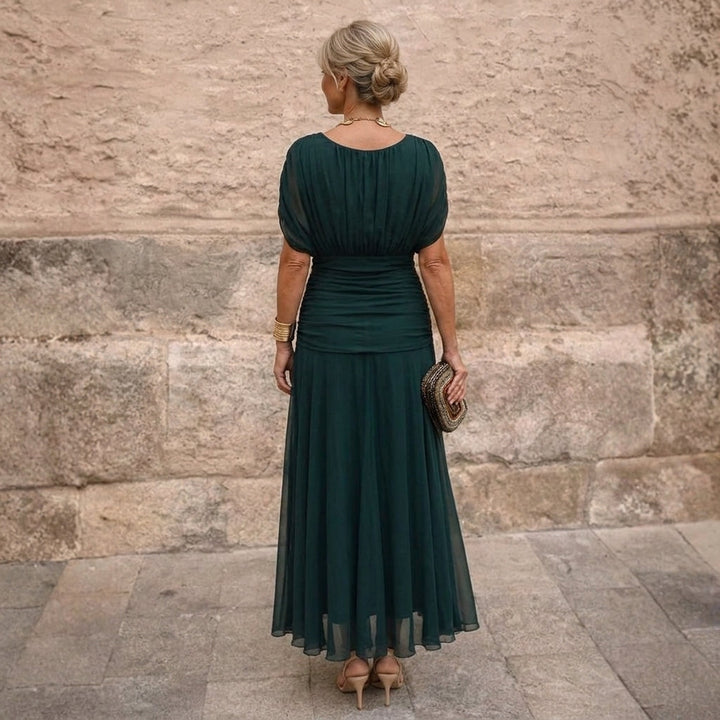 Emerald maxi dress with gathered back and sheer skirt, back view