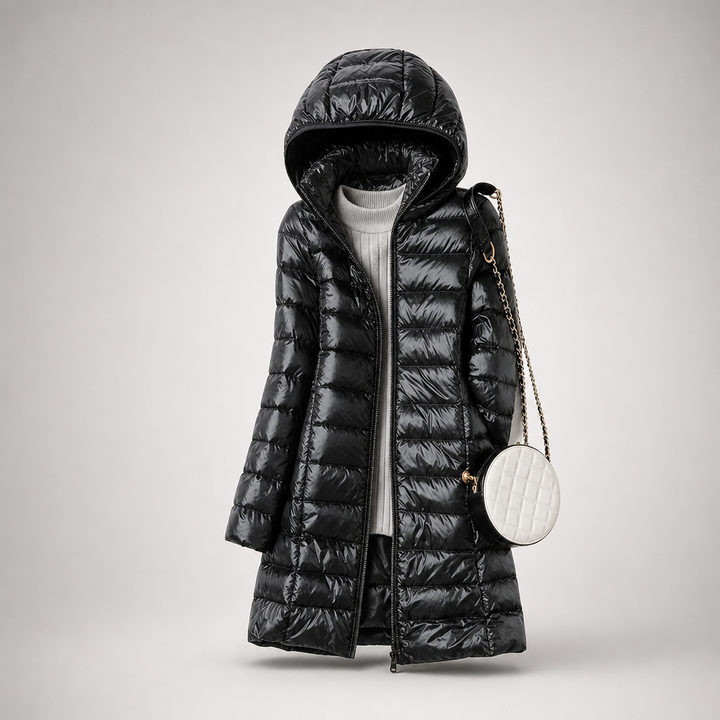 Black glossy long puffer coat with hood and a small white shoulder bag