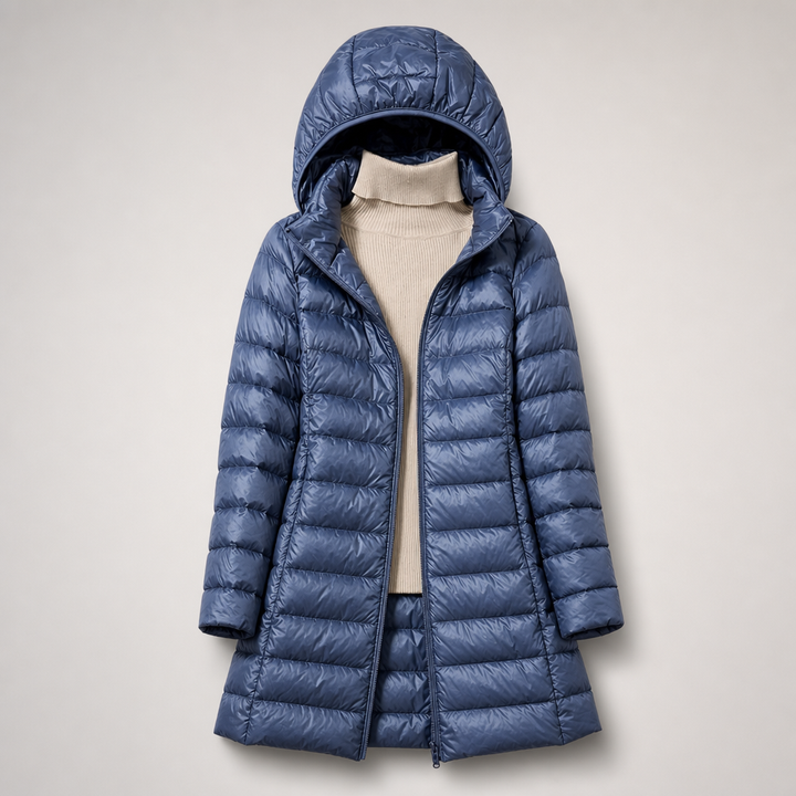 Blue lightweight hooded puffer coat worn open over a cream sweater
