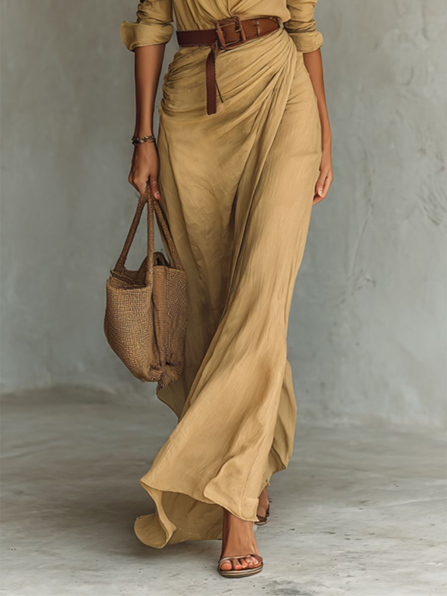 Khaki maxi dress skirt and belt detail with a woven handbag