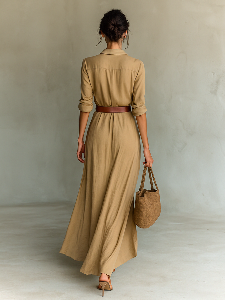 Back view of the khaki maxi shirt dress with belt and flowing skirt