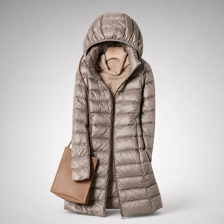 Khaki hooded quilted puffer coat with a tan tote bag