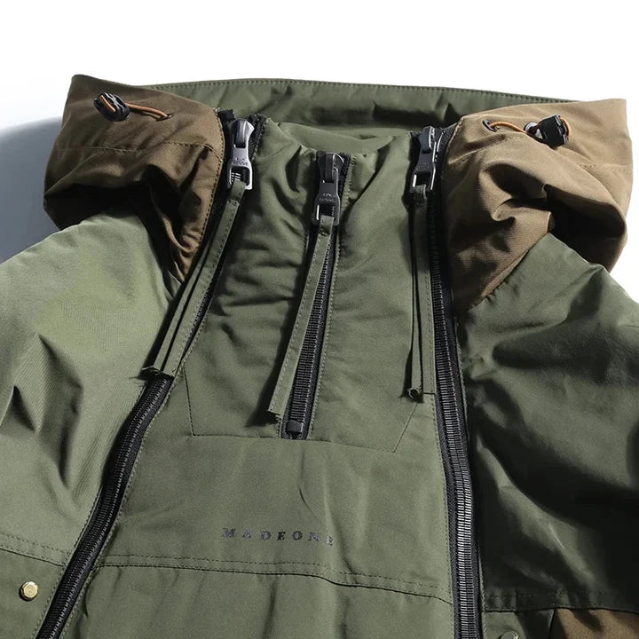Close-up of the olive anorak collar with two zippers and tan hood trim