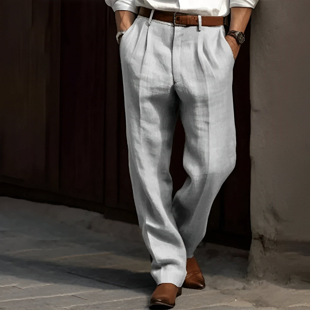 Men's light gray baggy pleated pants, front view on a model
