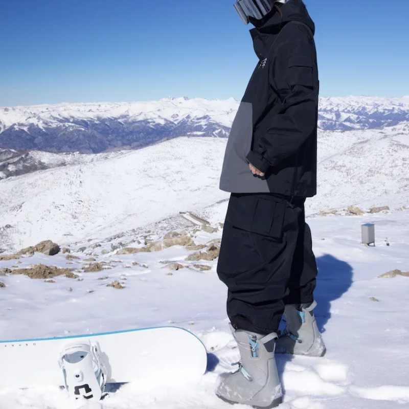 Black wide leg snow pants worn on a sunny mountain slope