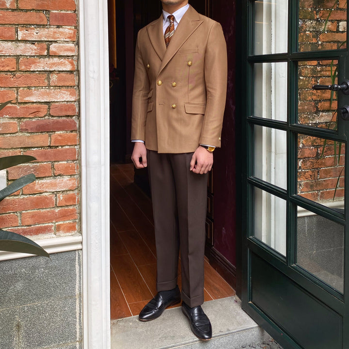 Full length view of the camel blazer with brown trousers and loafers