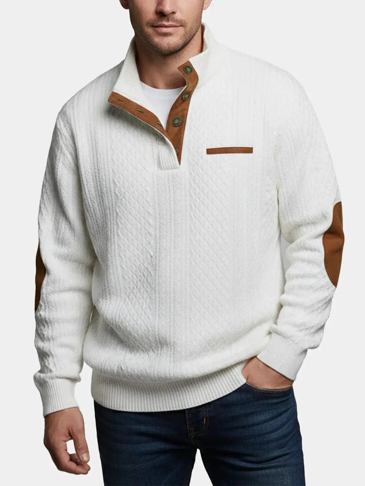 Man wearing the white cable knit mock neck sweater with brown elbow patches, front view