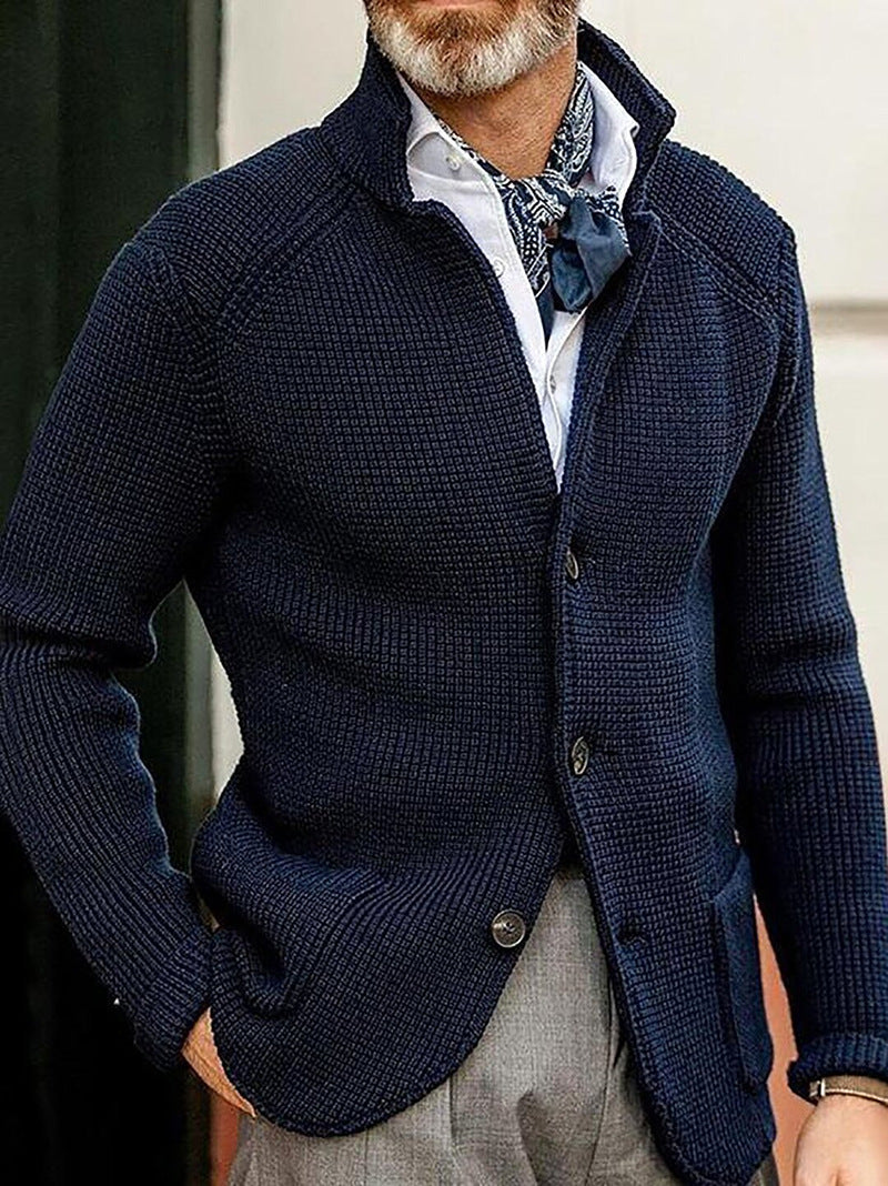 Navy button up knit cardigan with stand collar, shown on a standing model