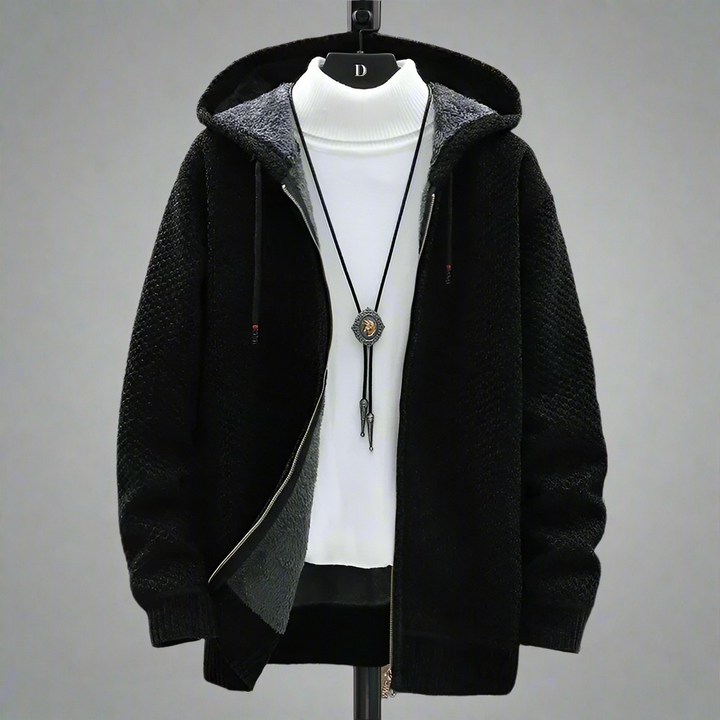 Black hooded zip up cardigan displayed open on a stand over a white top