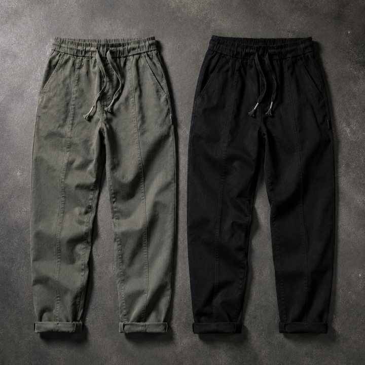 Olive and black drawstring joggers laid flat side by side