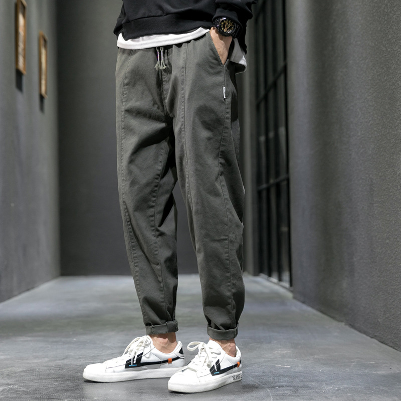 Men's cargo joggers in olive, tapered drawstring with cuffed ankles, worn with sneakers