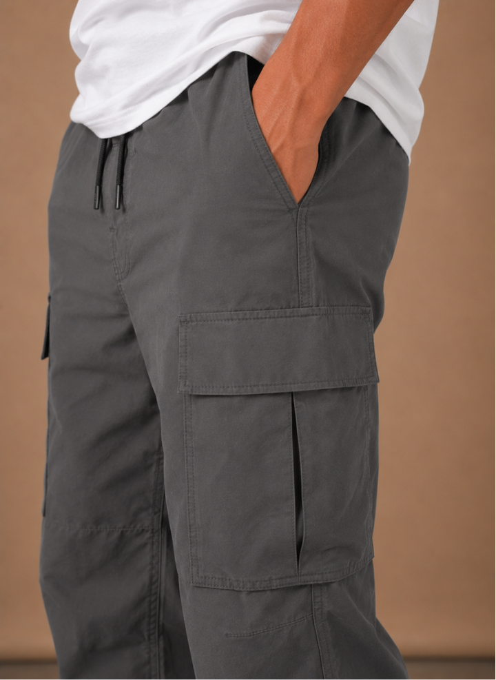 Close up of the charcoal drawstring waist and flap pocket