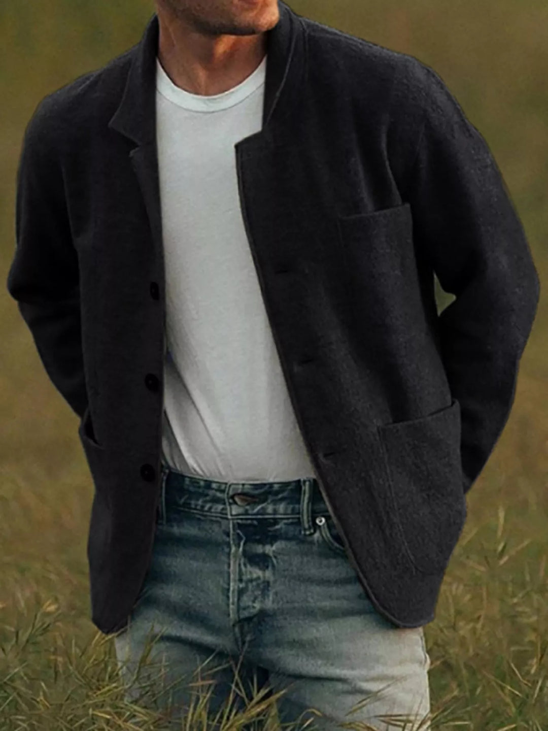 Black casual blazer with notch lapels and four-button front on a model outdoors
