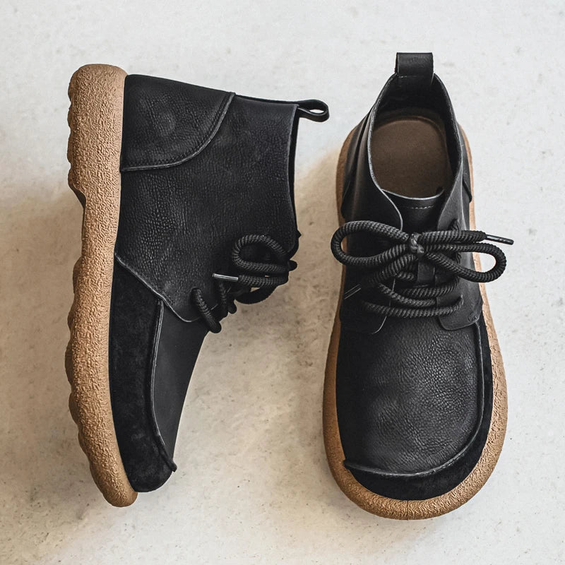 Pair of black lace up ankle boots with crepe sole, overhead view