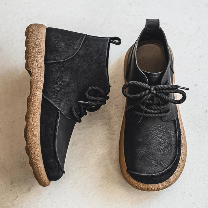 Pair of black lace up ankle boots with crepe sole, overhead view