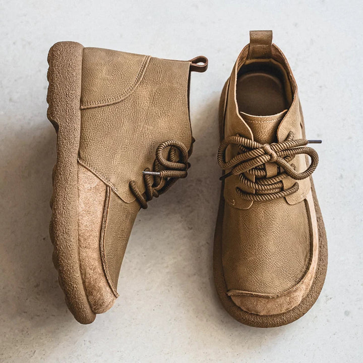 Pair of tan lace up ankle boots with crepe sole, overhead view