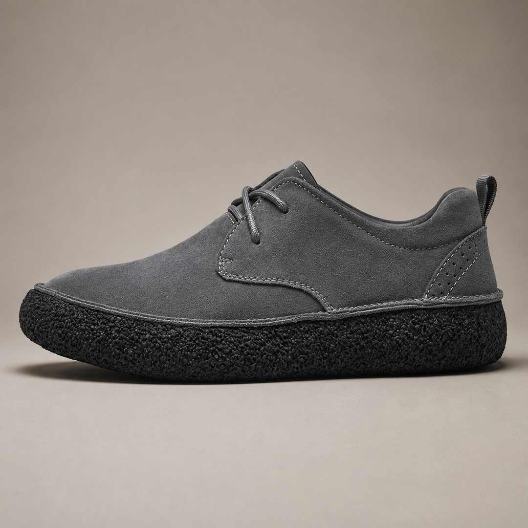 Ash gray low top shoe with laces and thick black crepe sole, side view