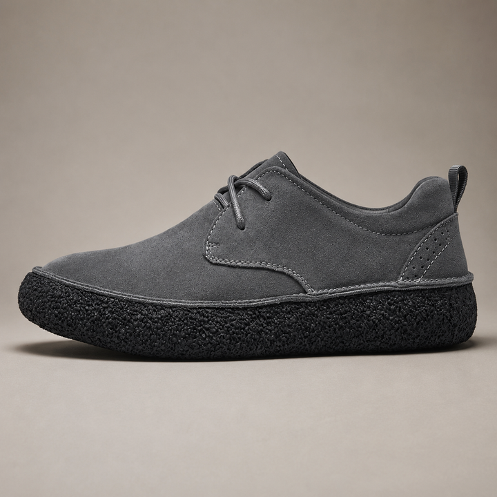 Ash gray low top shoe with laces and thick black crepe sole, side view