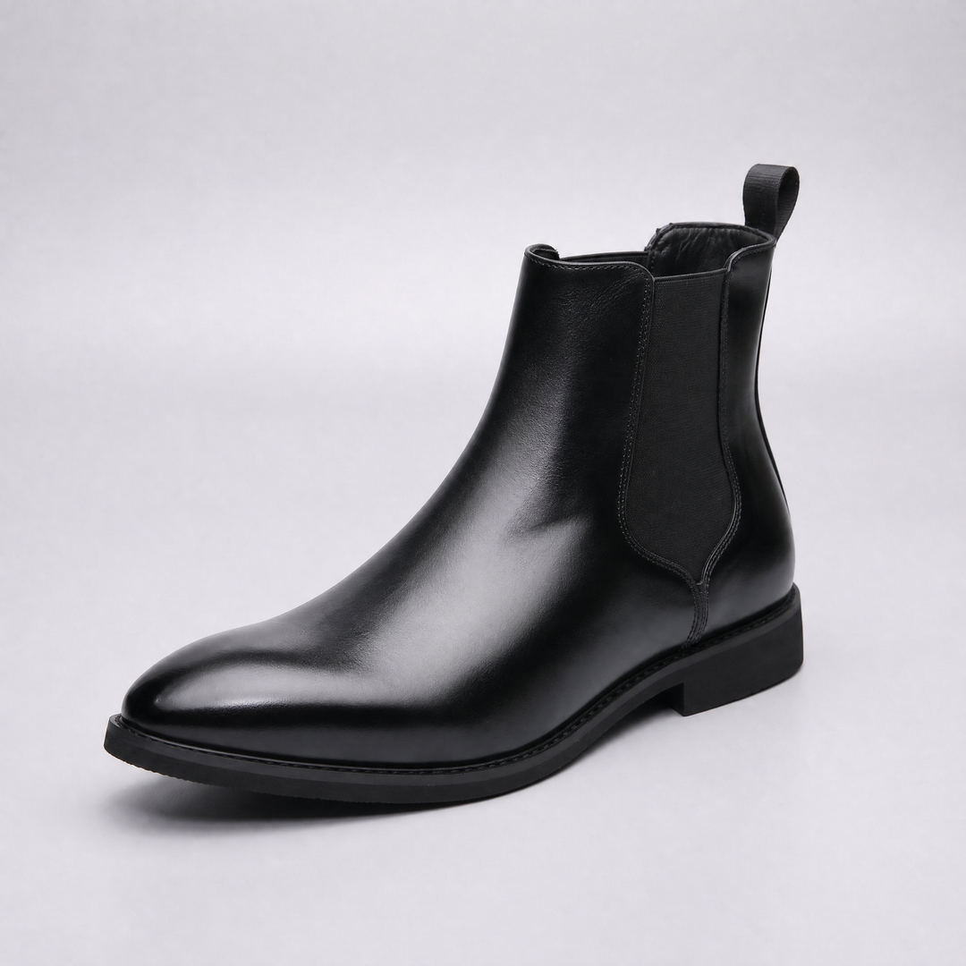 Black chelsea boot side view with elastic panel and back pull tab