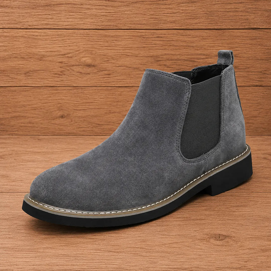 Dark gray pull on chelsea boot with stitched welt and black sole
