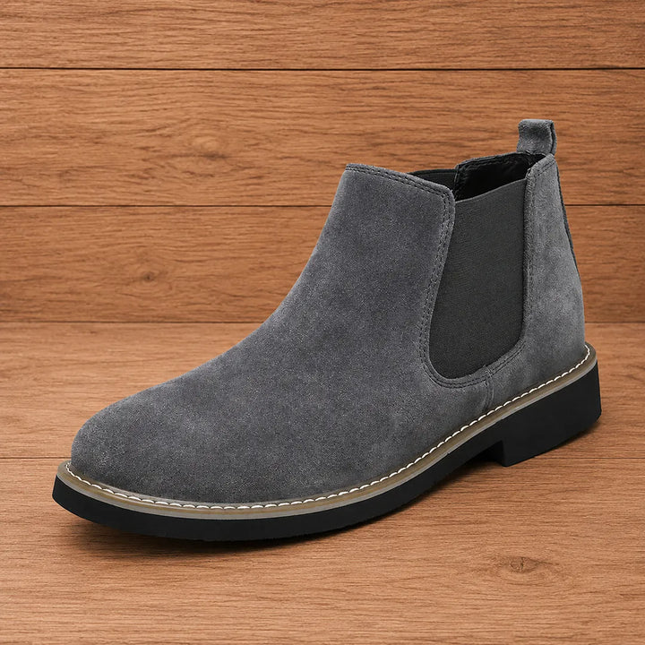 Dark gray pull on chelsea boot with stitched welt and black sole