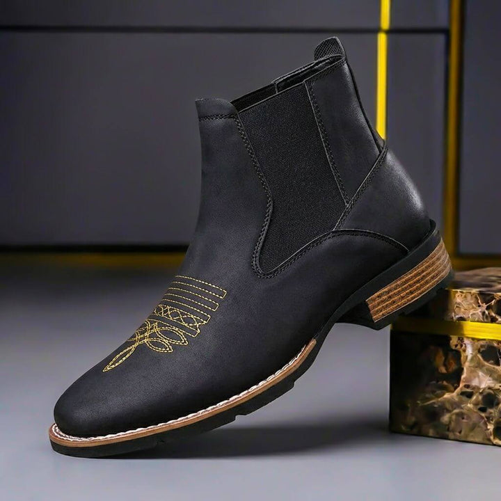 Black chelsea boot with elastic side panel and western stitching