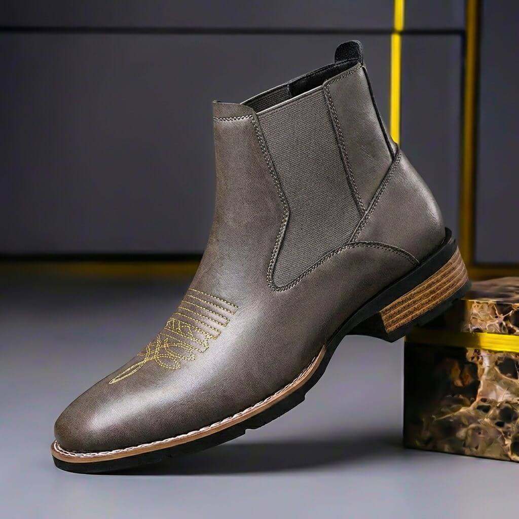Gray chelsea boot with gold toe stitching and stacked heel