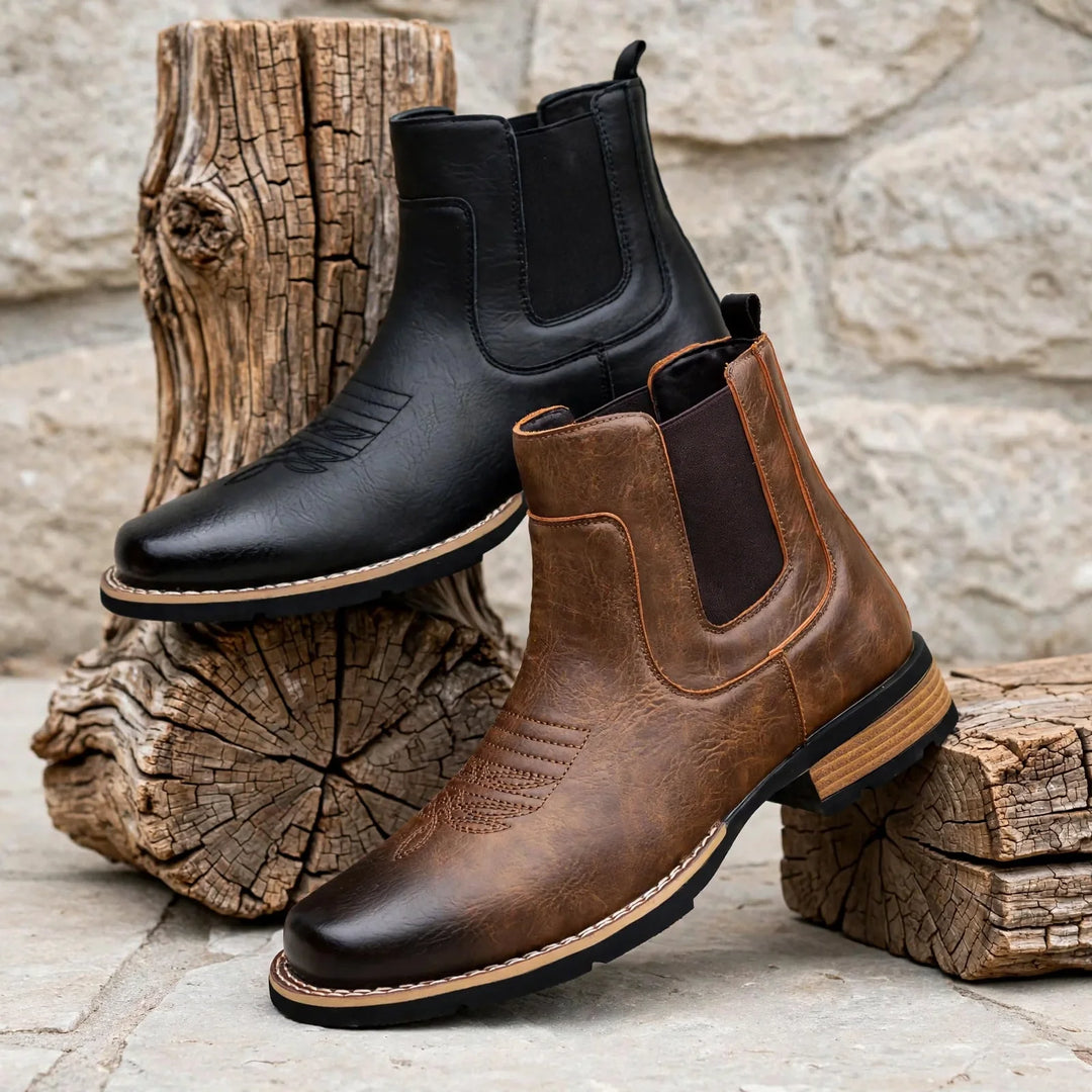 Black and brown Chelsea boots leaning together against tree stumps