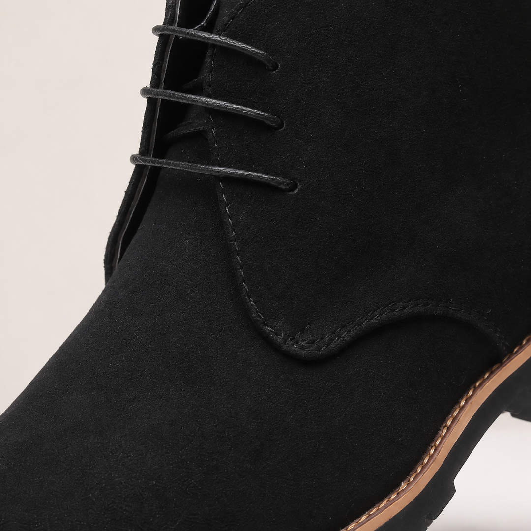 Close-up of the black laces, stitching and welt on the chukka boot