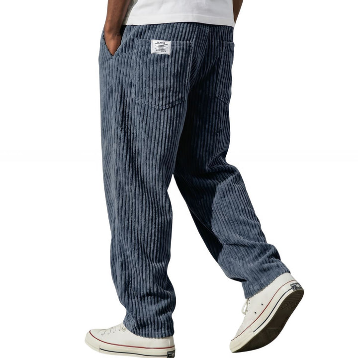 Blue corduroy pants, relaxed straight leg, walking side view