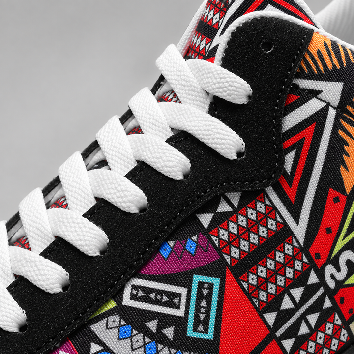 Close-up of white laces and colorful geometric print on the black sneaker