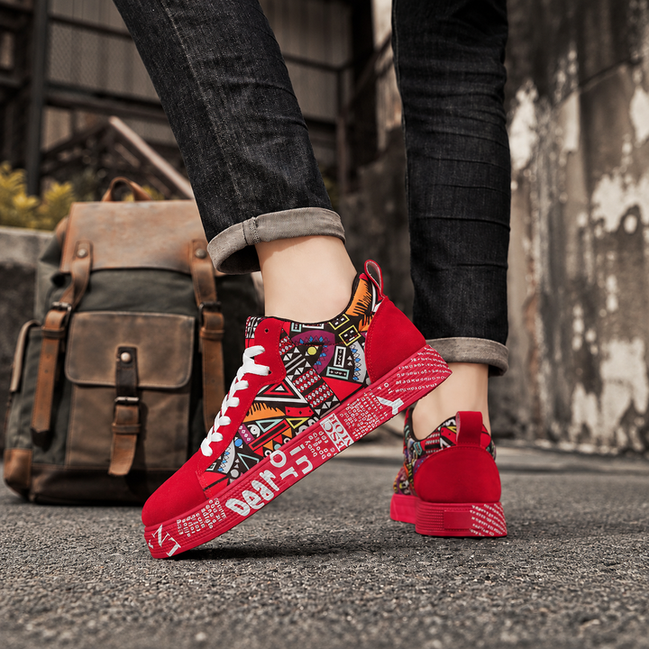Red graphic print sneakers worn with dark jeans beside a leather backpack