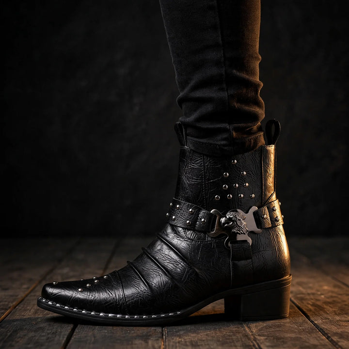 Black cowboy ankle boot worn with dark jeans on a wood floor