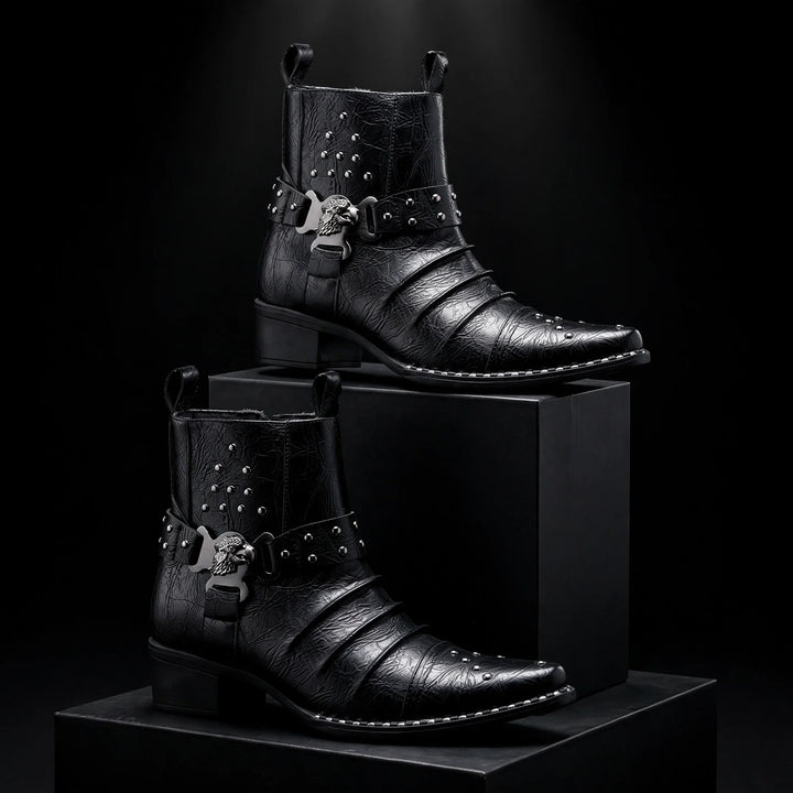 Pair of black harness ankle boots staged on dark blocks
