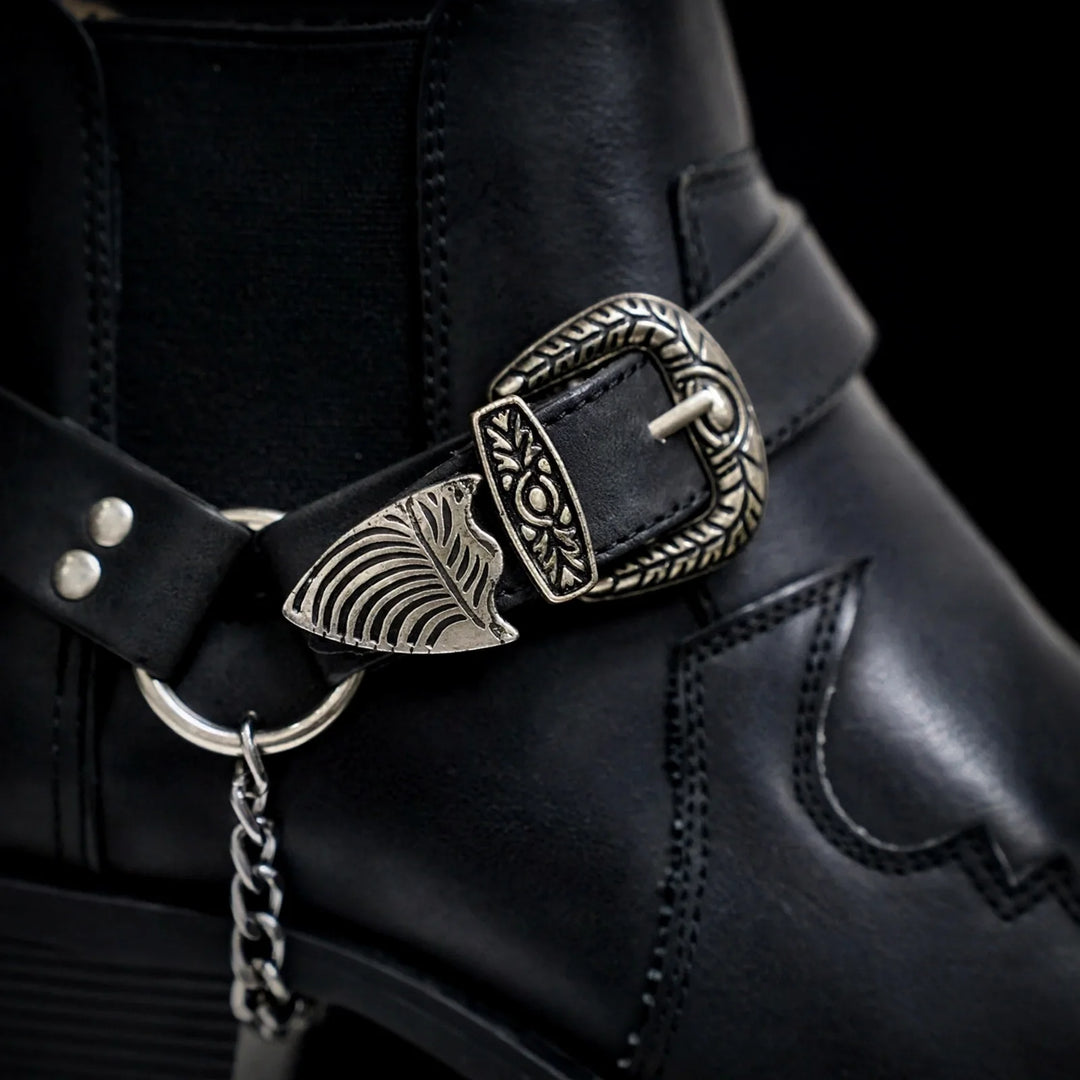 Close-up of the black boot ornate buckle, ring and chain