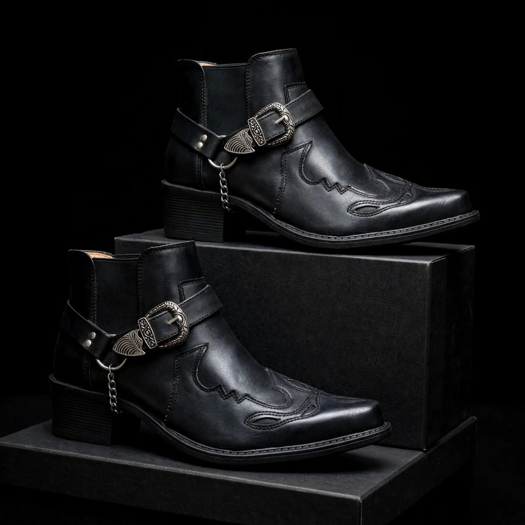 Two black harness ankle boots with western stitching on black blocks
