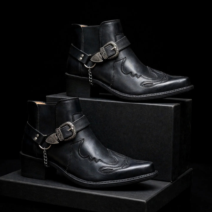 Two black harness ankle boots with western stitching on black blocks