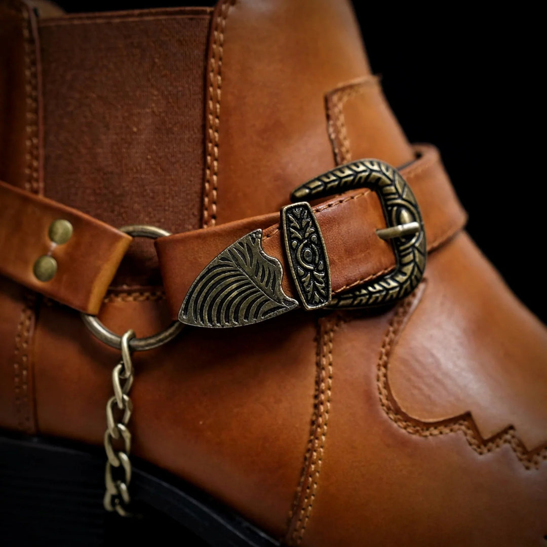 Close-up of the cognac boot harness buckle and chain detail