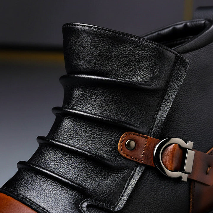 Close-up of the pleated black shaft and metal buckle strap on the ankle boot