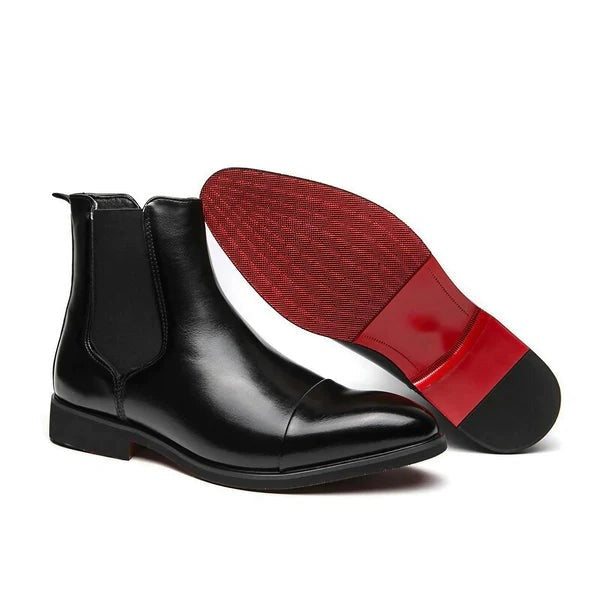 Black pointed toe slip-on boots shown from the side with red sole visible