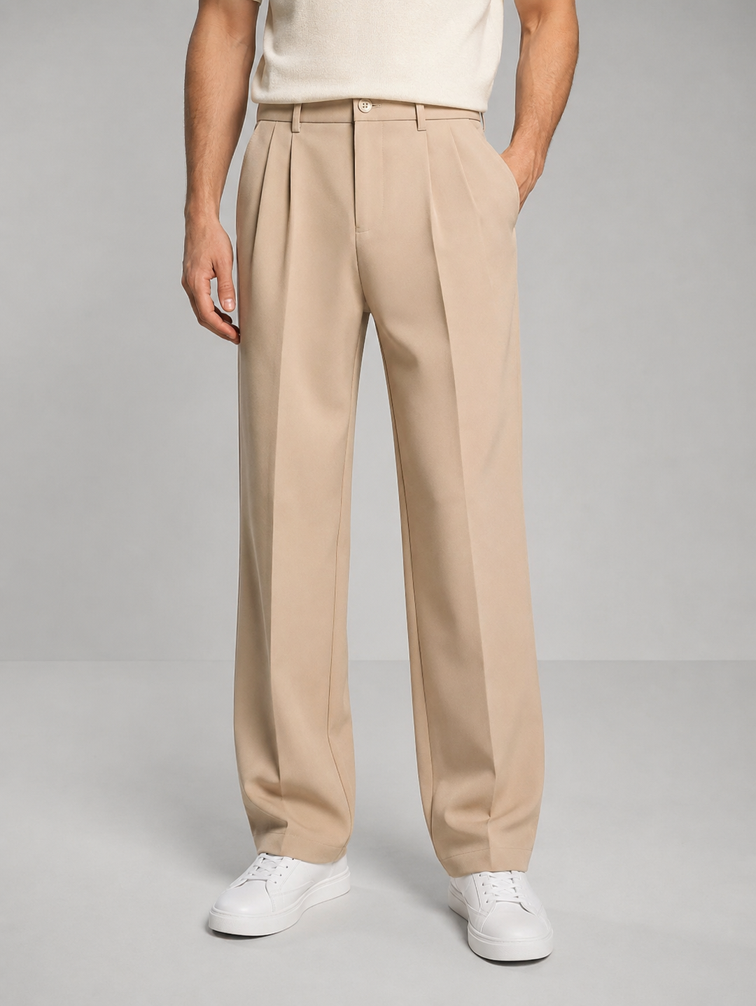 Men's beige pleated dress pants, front view on a model
