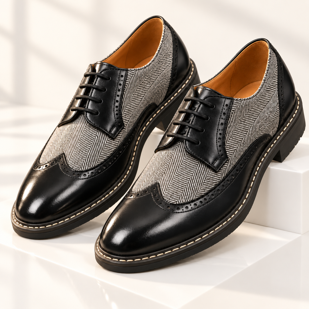 Pair of black wingtip brogues with gray herringbone panels and glossy toe caps