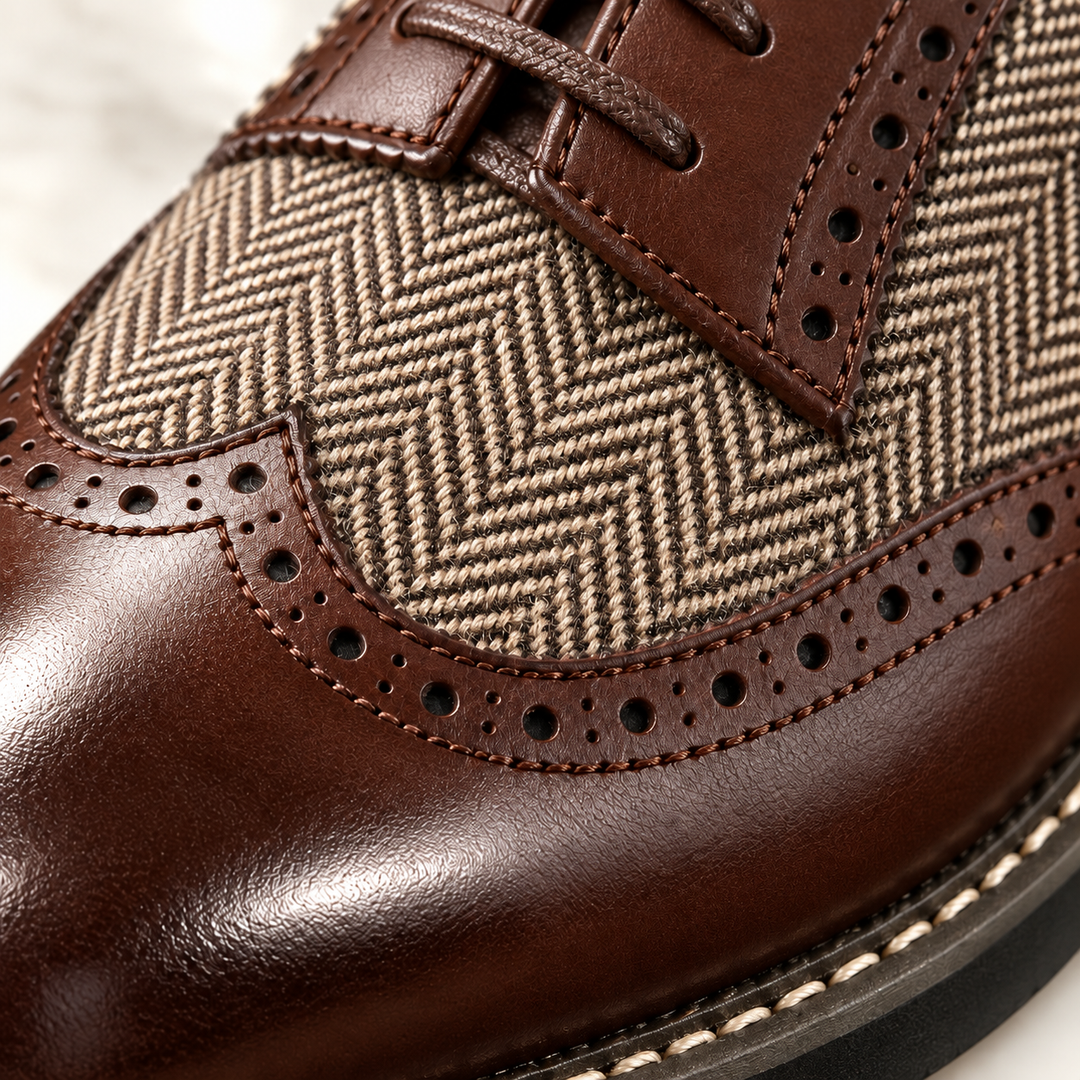 Close-up of the herringbone panel and perforated brogue toe on a brown shoe