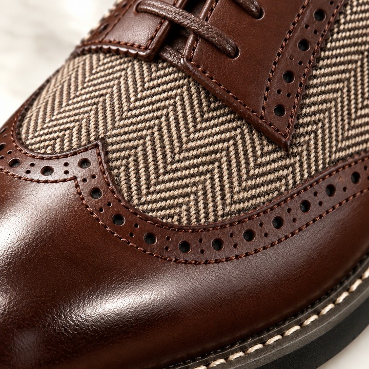 Close-up of the herringbone panel and perforated brogue toe on a brown shoe