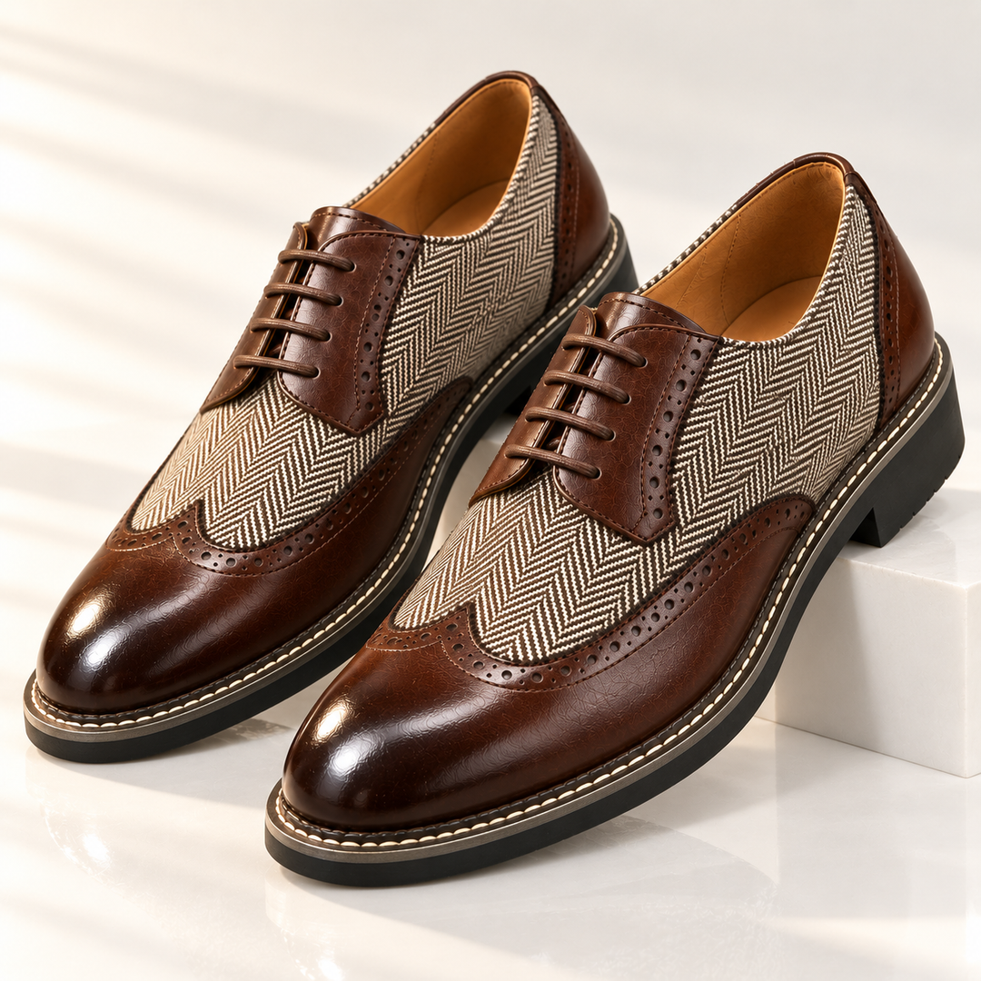 Men's dress shoes in brown, wingtip brogue with herringbone panels, pair on display